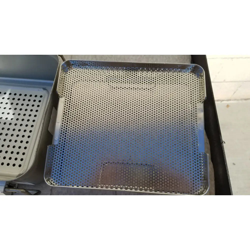 Stainless steel perforated tray with hexagonal mesh and reinforced edges for case genesis sterilization container