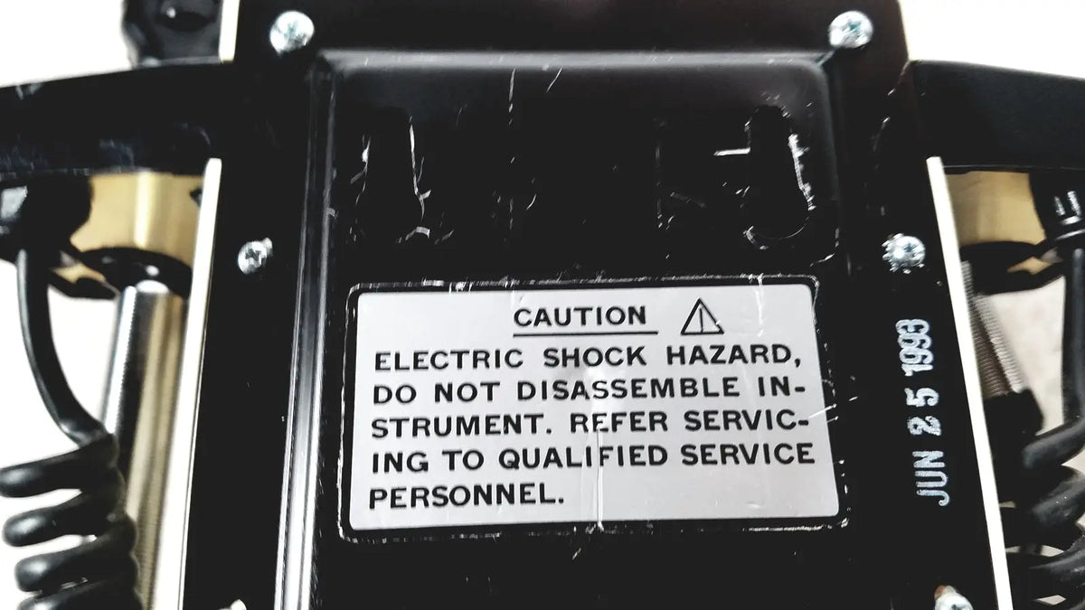 Black plastic housing with white caution label dated june 2 1983 on back of thermo scientific slidemate laboratory printer