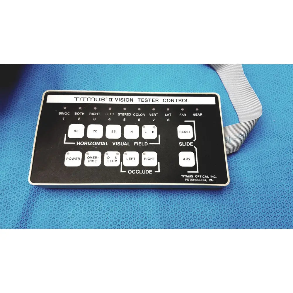 Black titmus optical titmus ii vision tester control panel with white labeled buttons and silver ribbon cable
