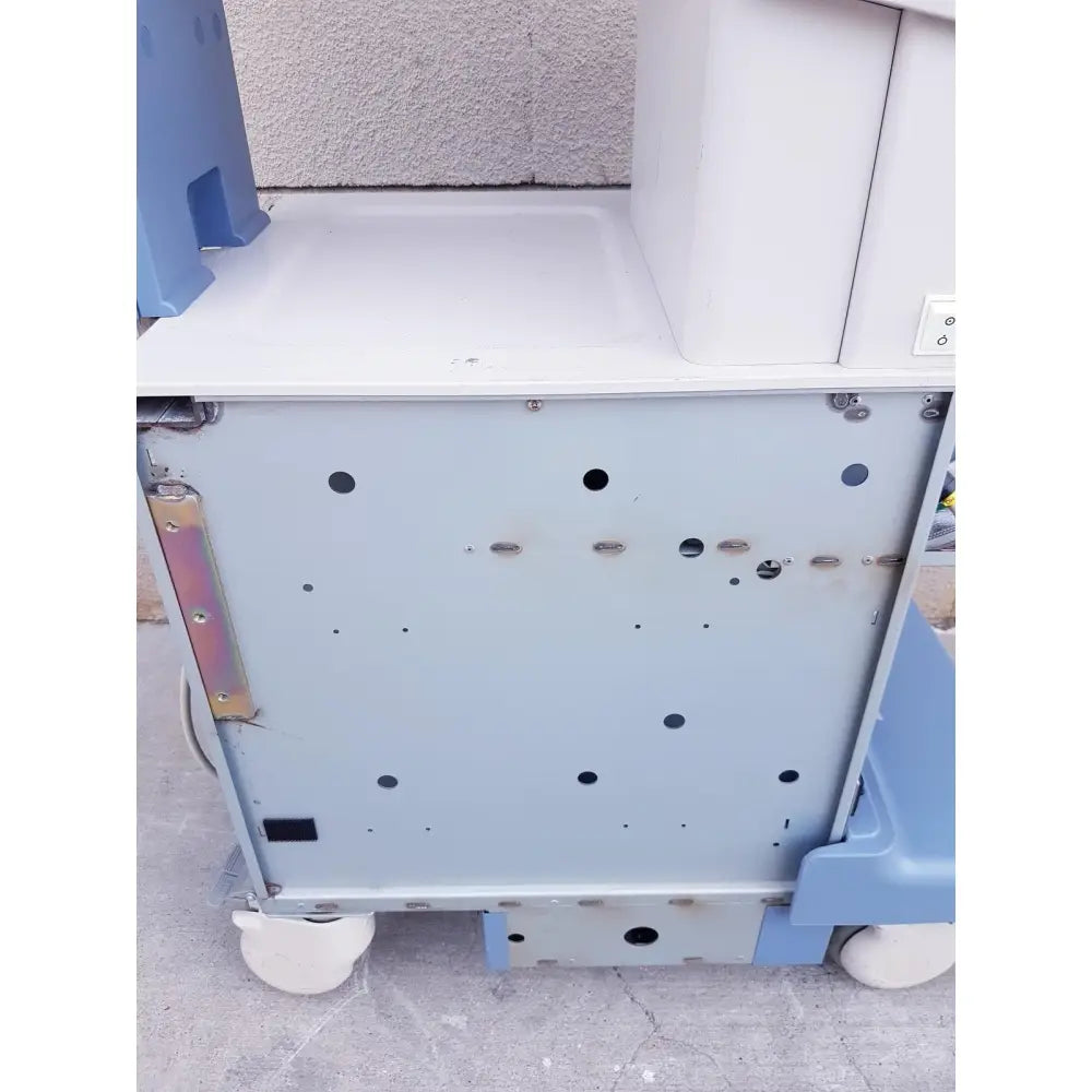 Light blue medical cart with white wheels and metal panel with holes for toshiba nemio ultrasound machine reuse medical parts as-is
