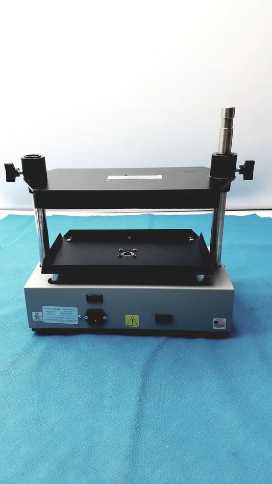 Black and silver industrial press machine with adjustable clamps and flat platform in tripath imaging multi-vial vortexer 30cr000106