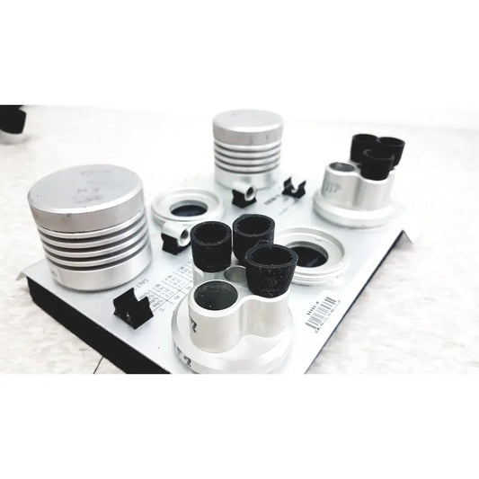 Silver and black cylindrical optical components on white tray of vaisala hmk15 humidity calibrator for probes and transmitters