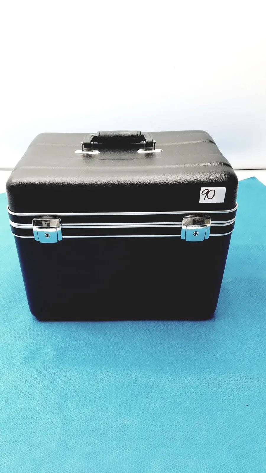 Black hard-shell cosmetic case with silver trim and light blue latches for verathon bladderscan tissue equivalent phantom