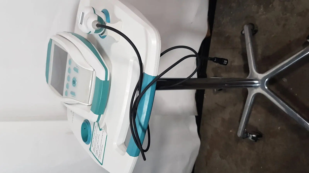 White and teal verathon bvi 9400 bladder scan ultrasound scanner with digital screen and rolling stand with cables