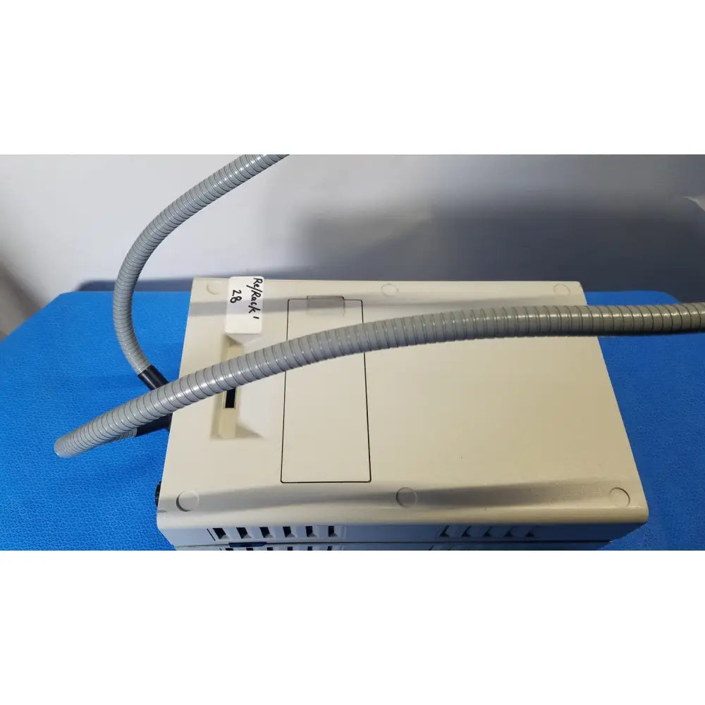 Beige plastic volpi intralux 5000 fiber optic illuminator with flexible gray corrugated hose and dual gooseneck light