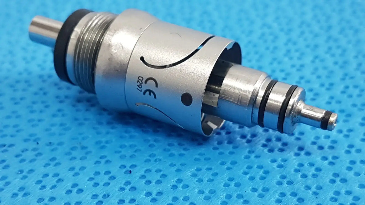 Silver w&h handpiece coupler with black rubber seals and engraved ce marking for dental connector use