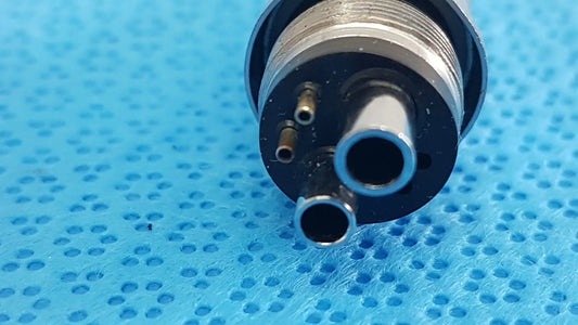 Silver metallic w&h handpiece coupler dental connector with three cylindrical ports and threaded collar for high-speed use