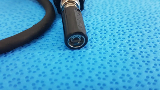Black rubber-coated welch allyn bulb cable cord with metallic threaded end and embossed branding for illuminator bulb cable use