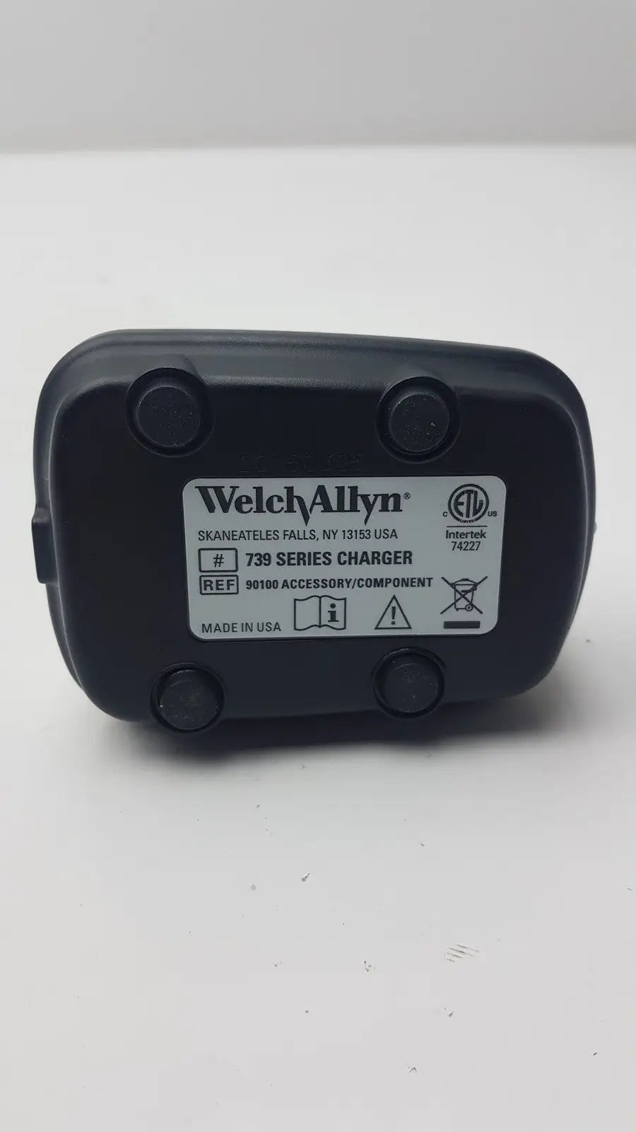 Black plastic welch allyn 739 series charger with white label showing model and certification for reuse medical use