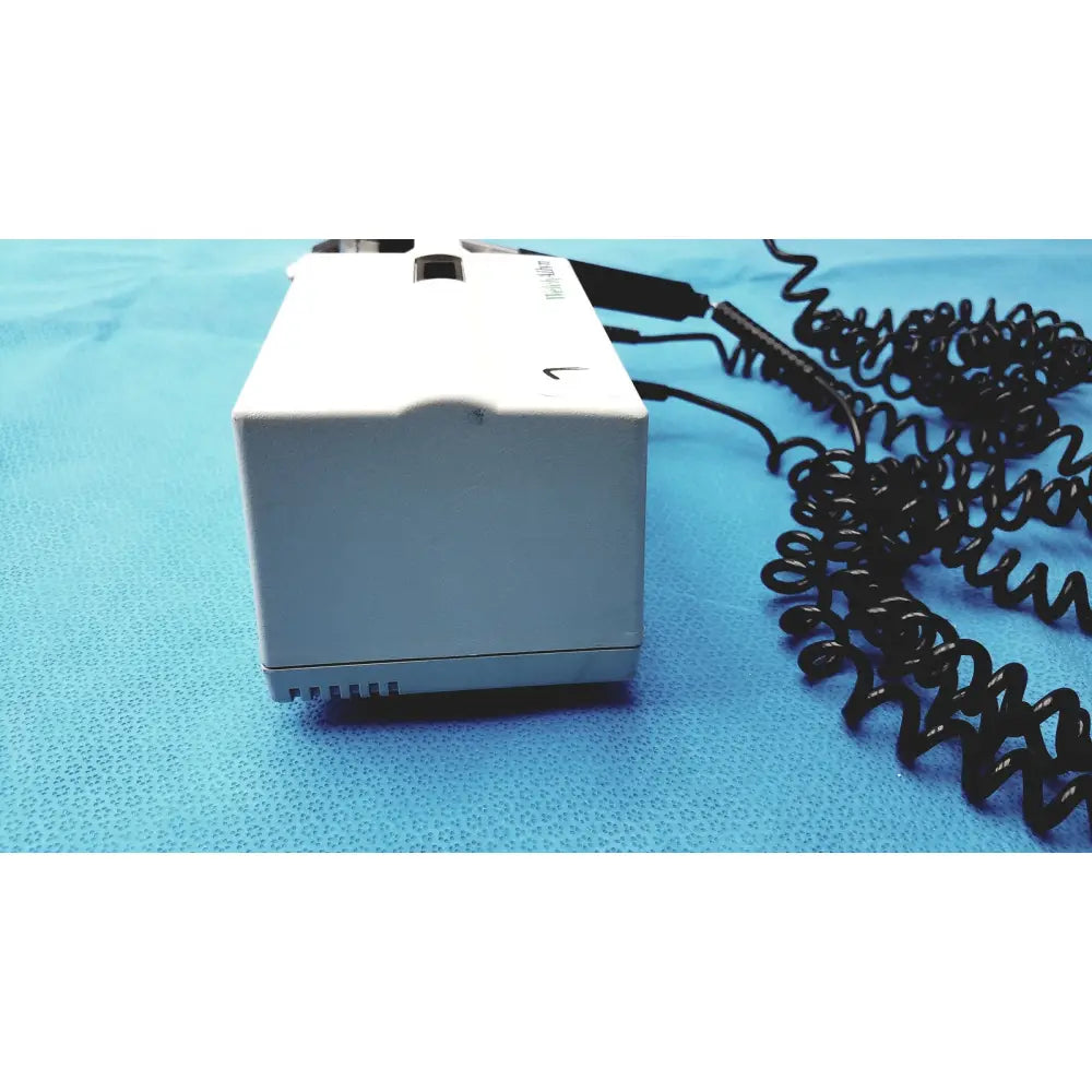 White rectangular welch allyn integrated wall diagnostic system with black coiled cables for bp and otoscope use