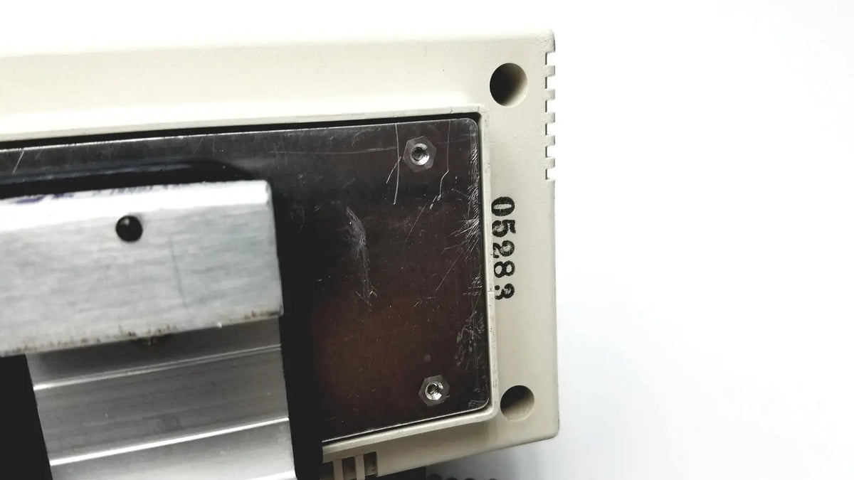 Beige plastic housing with black metal panel and engraved serial number 05283 on the back of welch allyn series transformer otoscope