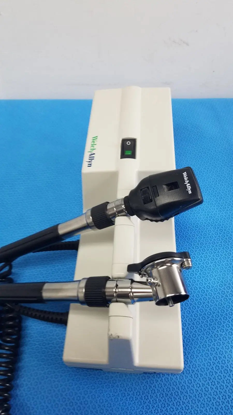 Welch Allyn 767 wall transformer with white and black coaxial ophthalmoscope featuring a sleek ergonomic design