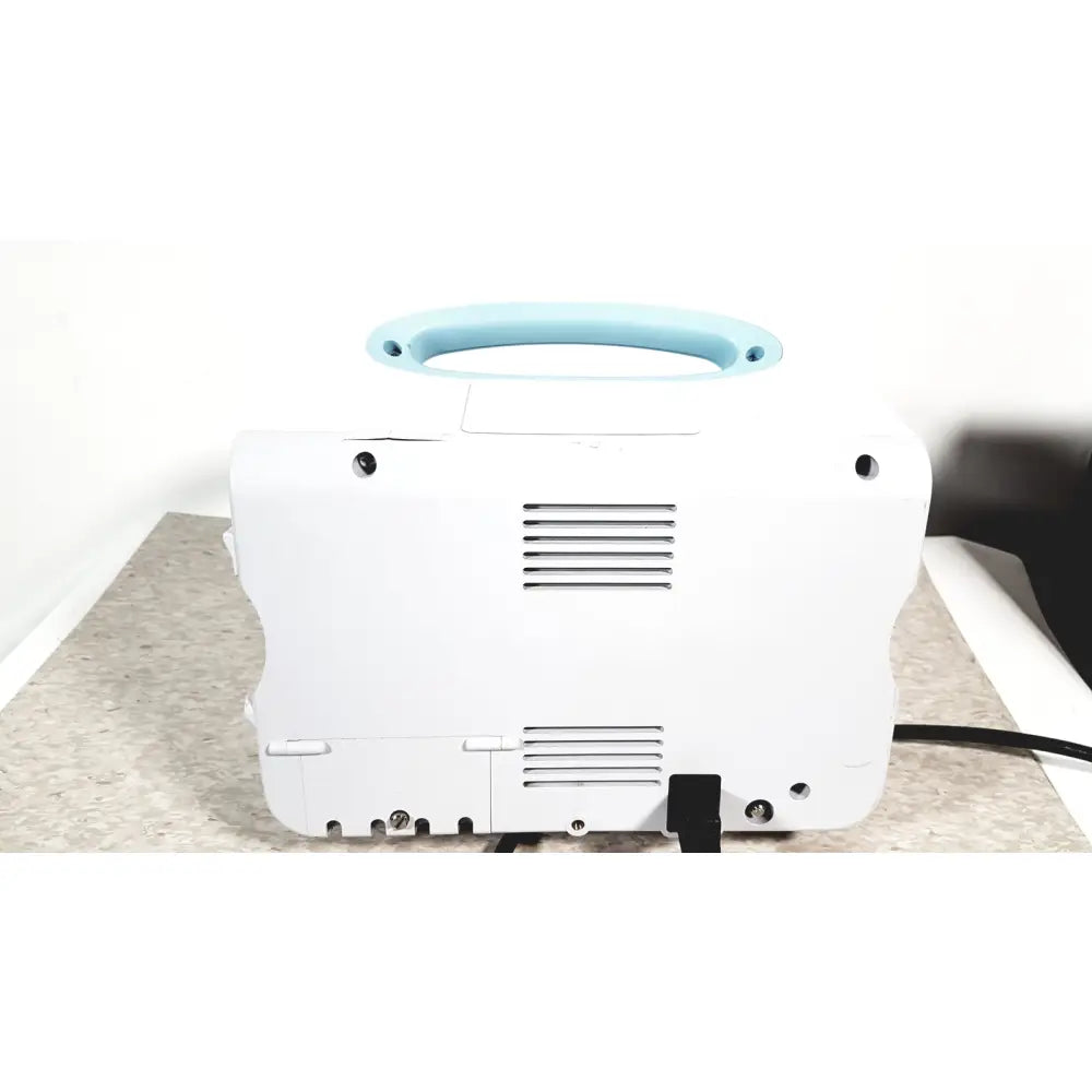 White portable welch allyn connex 6000 series vital signs monitor with light blue handle and ventilation slits