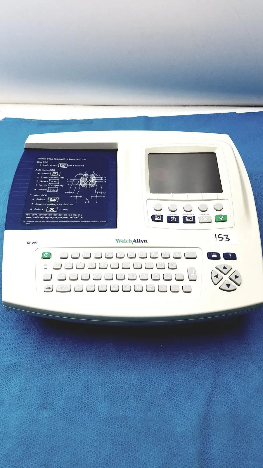 White Welch Allyn CP200 EKG ECG monitor with built-in keyboard, small screen, and blue instructional panel for cardiac use