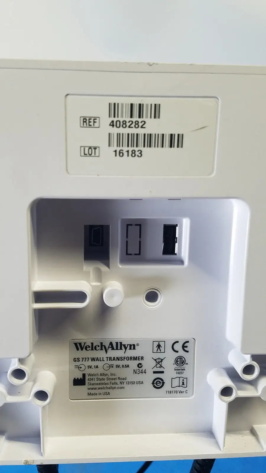 White plastic welch allyn gs 777 wall transformer with molded slots and label showing model and safety certifications
