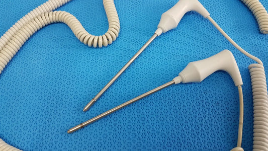 Two white-handled welch allyn probes with metallic shafts and coiled beige cords for rectal use lot of 2