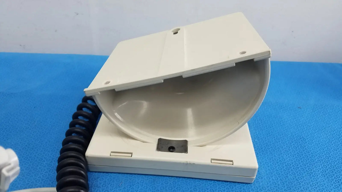 Off-white plastic telephone handset cradle with coiled black cord for welch allyn tycos mount aneroid sphygmomanometer