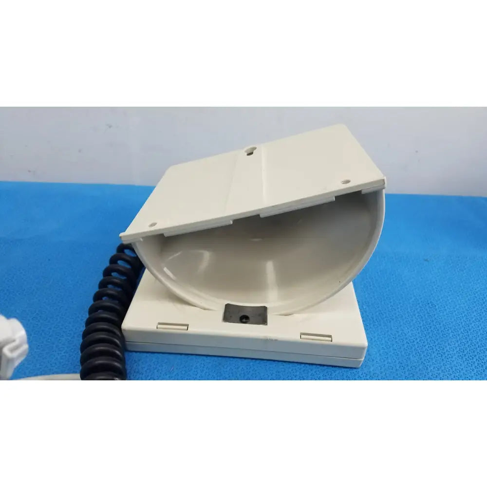Off-white plastic telephone handset cradle with coiled black cord for welch allyn tycos mount aneroid sphygmomanometer