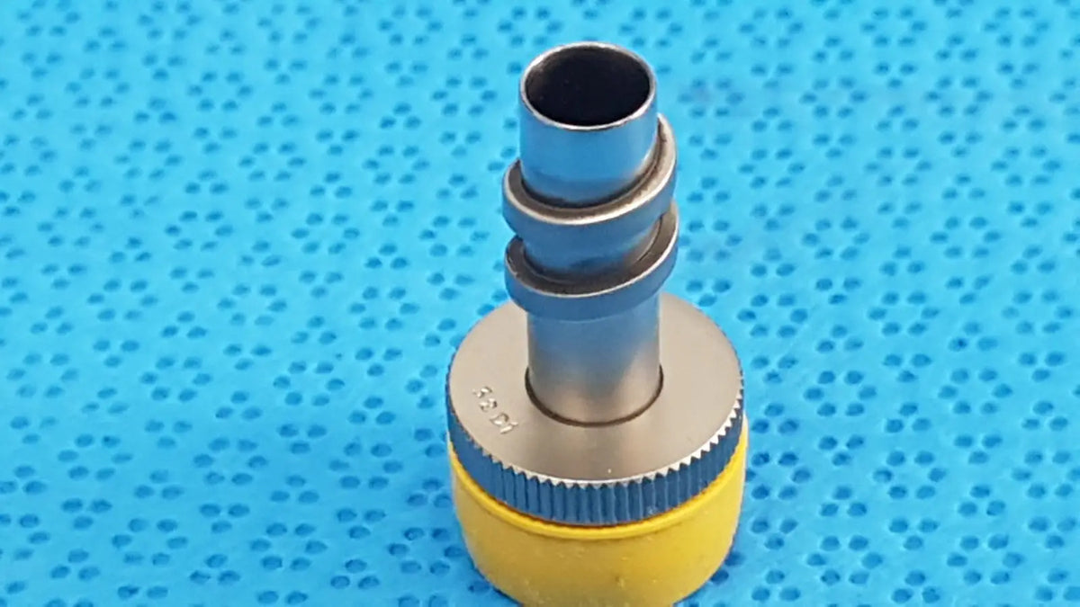 Wolf stainless luer-lock tube connector in yellow and silver with textured grip ring for surgical instrument fitting