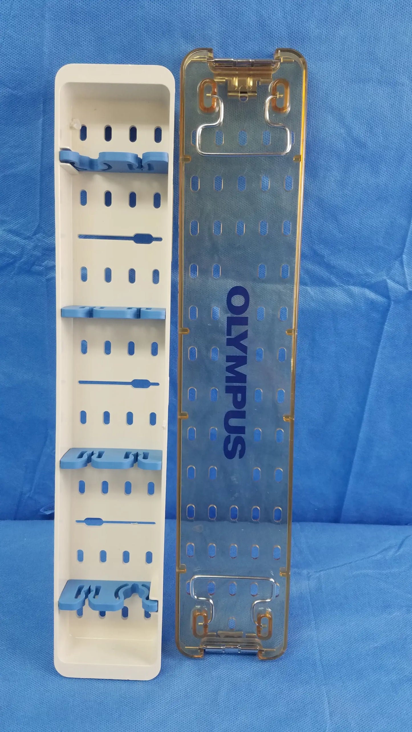 Transparent blue olympus sterilization tray with gold edges and slots for organizing endoscopic working insert tools