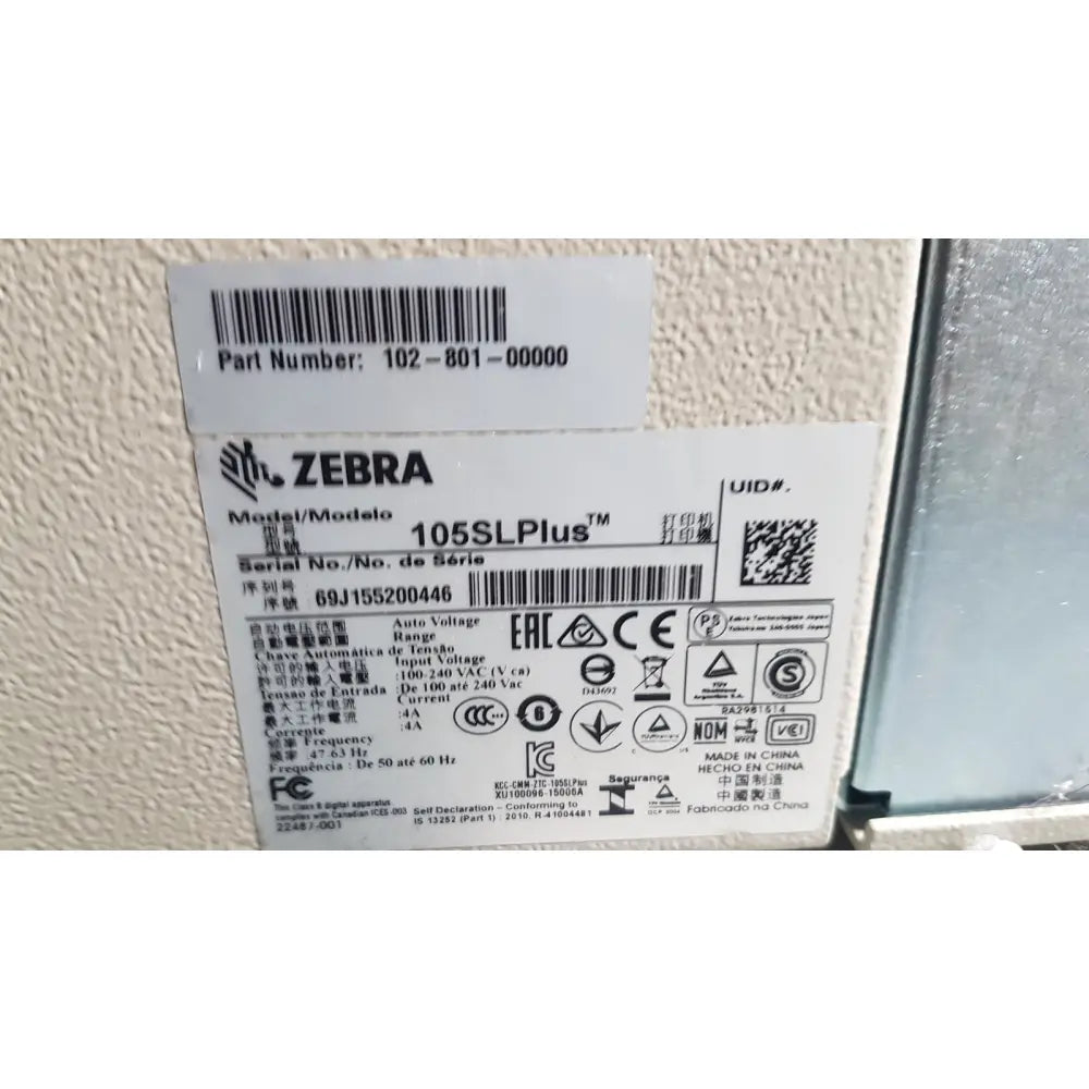 Zebra 105sl plus usb ethernet thermal transfer label printer with black text barcode label showing model and serial info