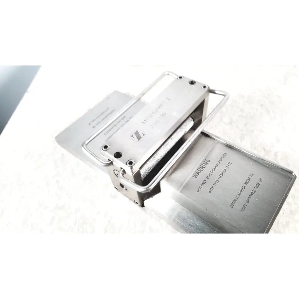 Silver metallic sennheiser m400i earphone with sleek rectangular design and engraved branding shown with zimmer meshgraft dermatome ii 2195-100