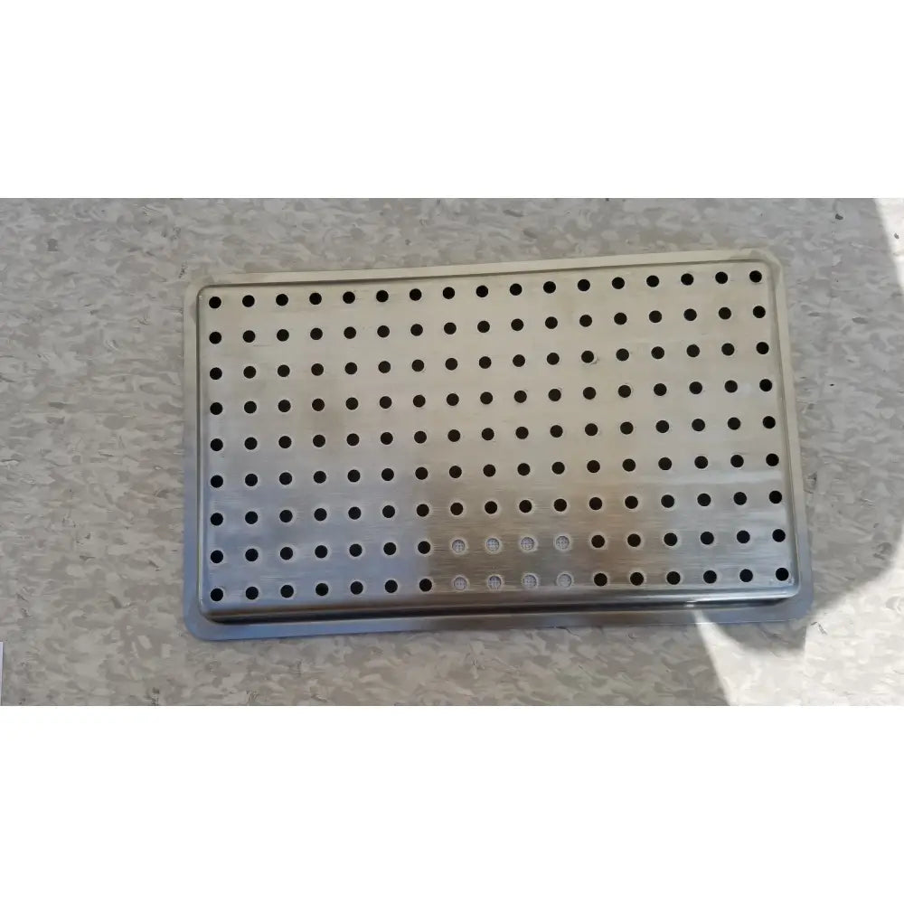 Rectangular stainless steel tray with circular holes designed for one layer of instrument sterilization case use