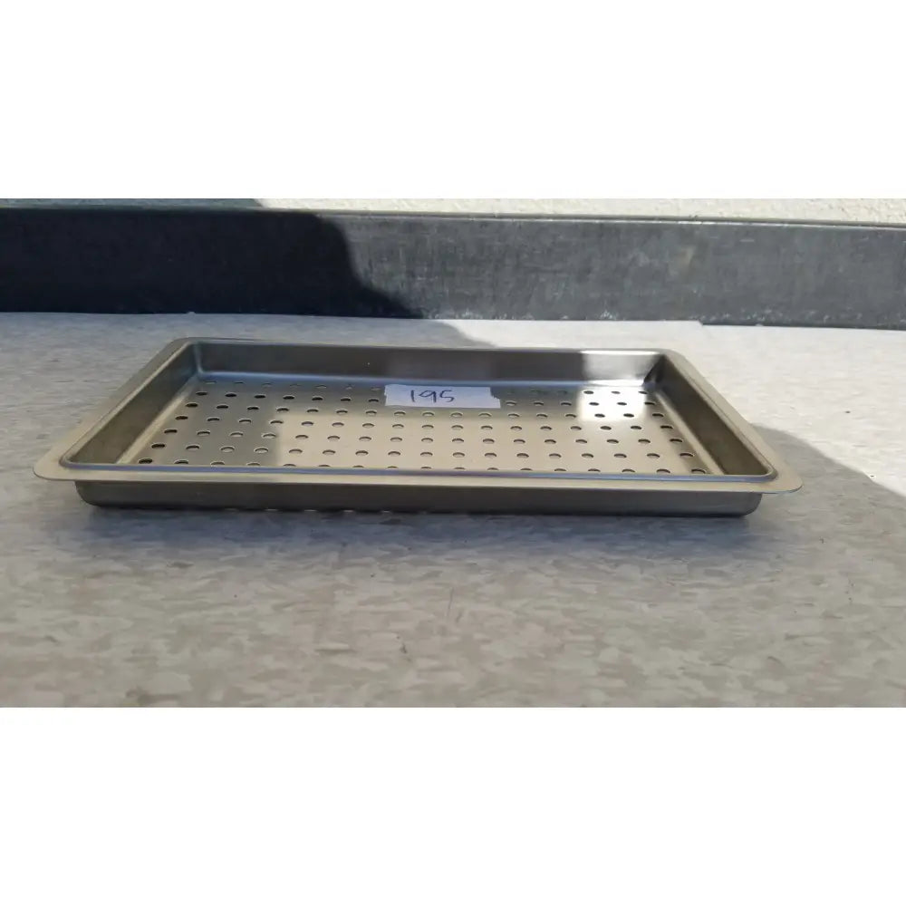Stainless steel rectangular tray with perforated grid and raised edges for instrument sterilization case use