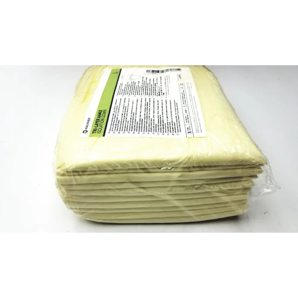 A stack of pale yellow tri layer isolation gowns packaged in clear plastic with white and green label case halyard tri