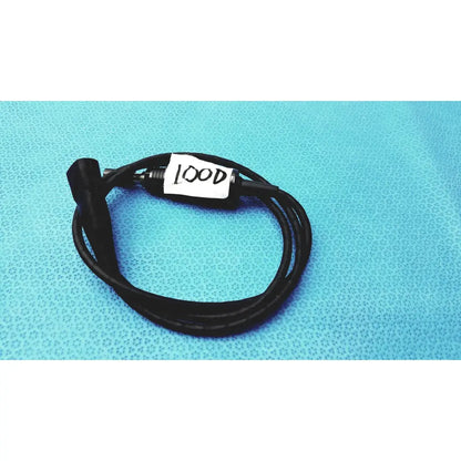 Black coiled 100cm smartwatch charging cable with metallic connector and safety protection features labeled lood