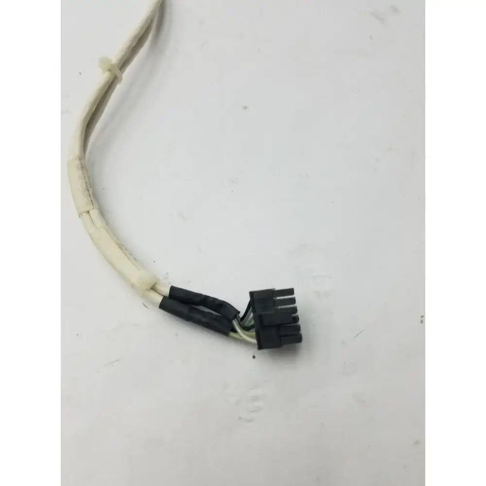 Black plastic 12 pin female cable connector with multiple pins attached to white and black insulated wires