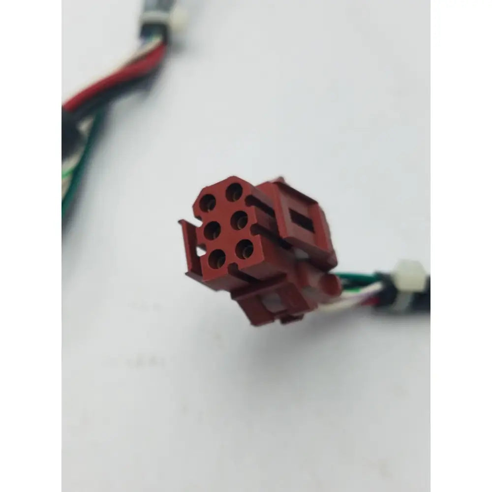 Red plastic 14 pin female connector with six circular openings and rectangular housing for cable harness and wire connector cable