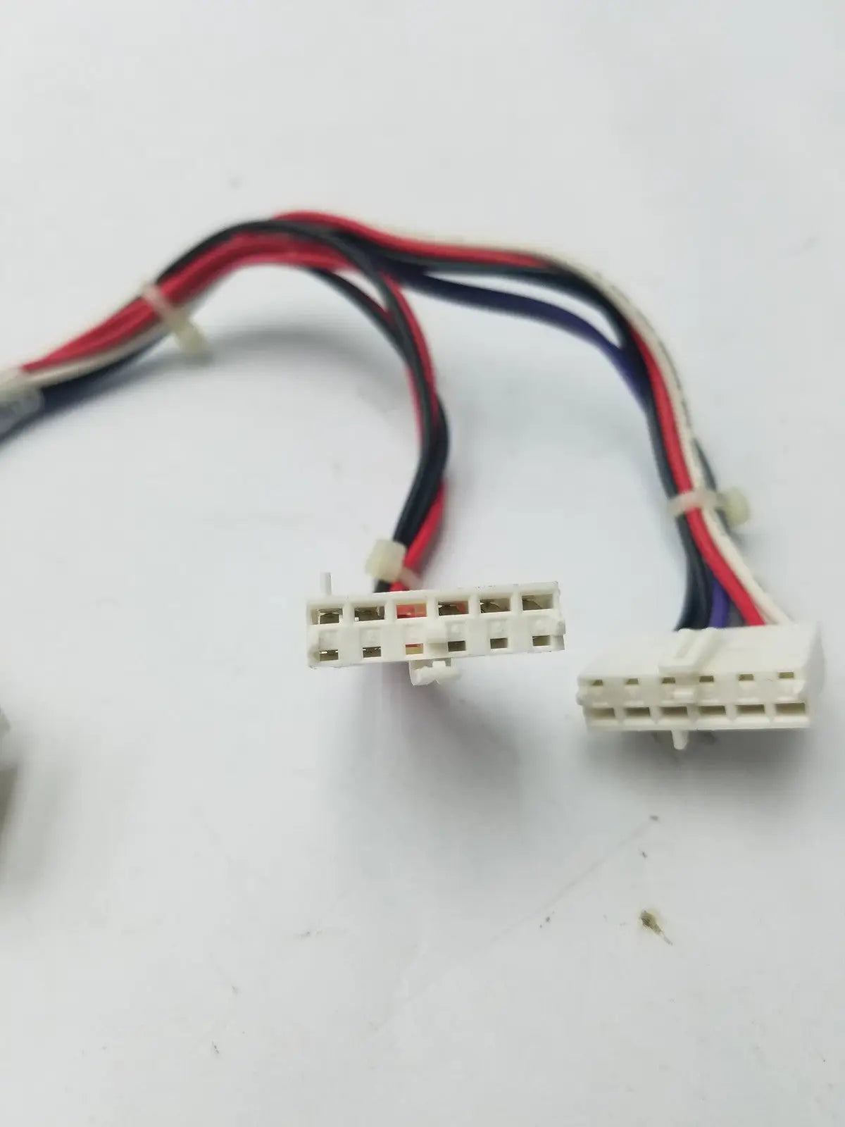 White plastic 14 pin female connector cable harness with red black and blue wires bundled together