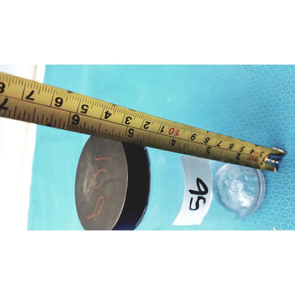 Yellow metal tape measure with black markings and red numbers shown alongside 16 oz glass juice bottles set of 8 reusable beverage containers
