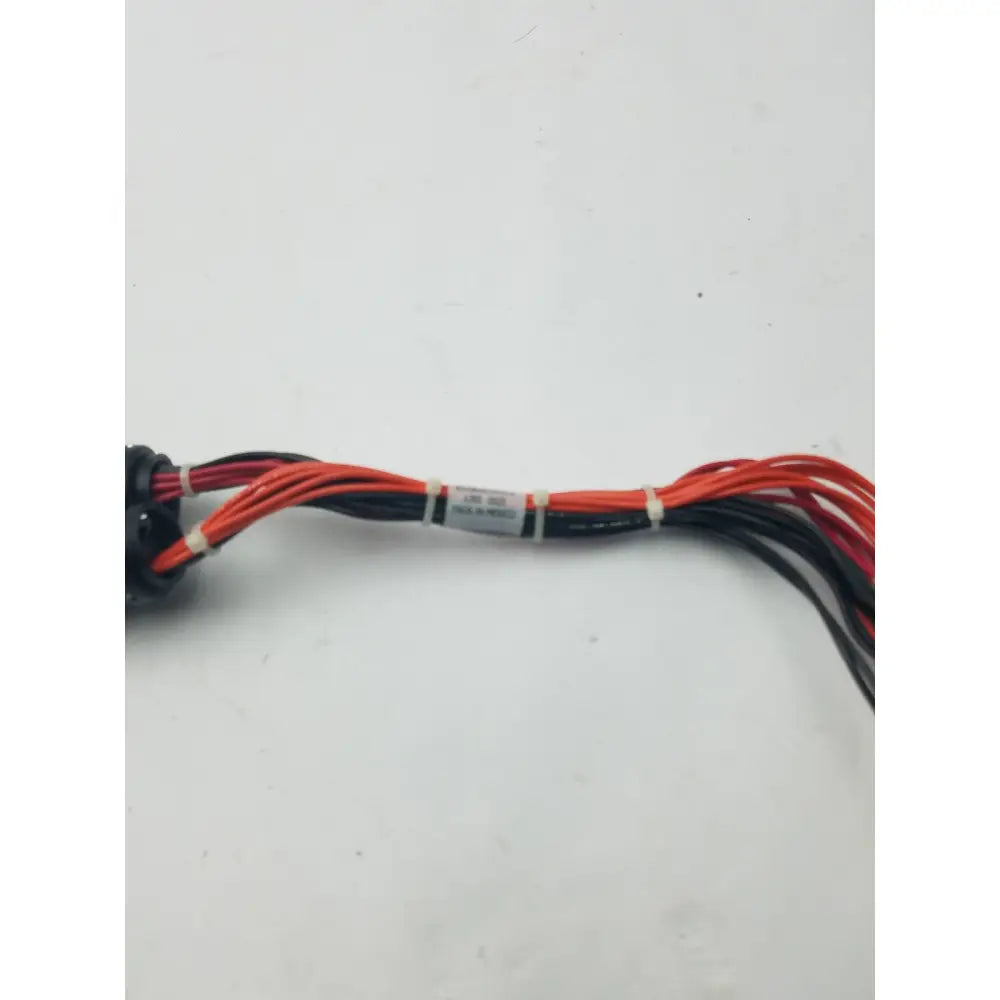 A bundle of red and black wires with a white label in a 16 pin female to pin male wire harness equipment cable
