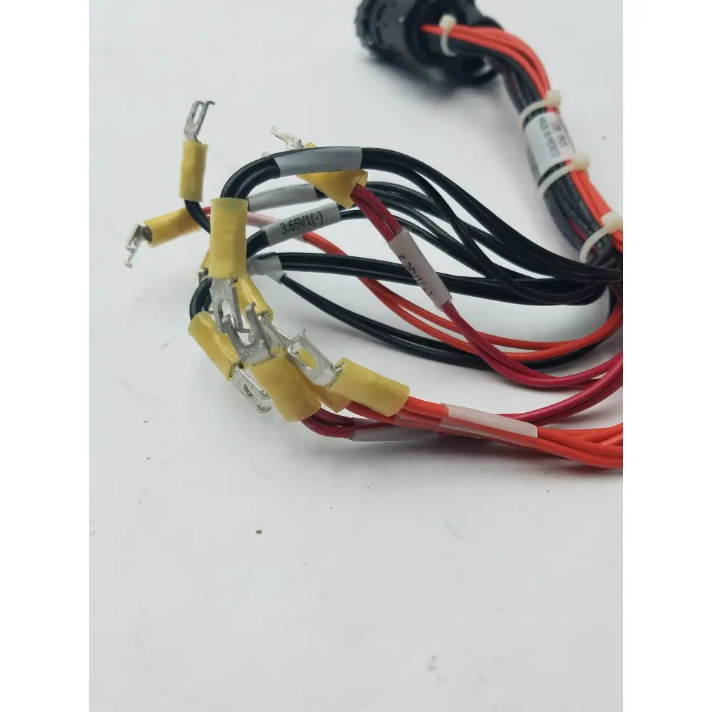 A bundle of red and black wire harness with yellow heat shrink tubing and labeled connectors for pin male wire use