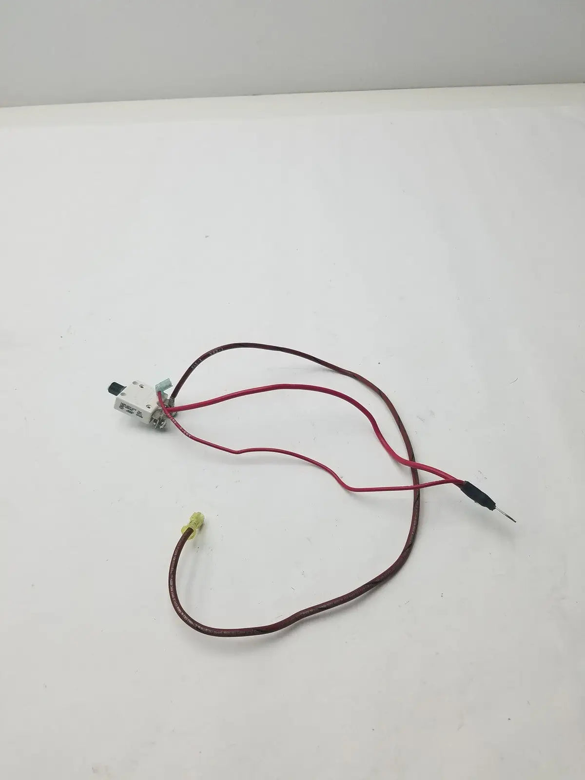White plastic 70a microswitch 1648-009-070 with red and brown wire leads and black capped insulation visible