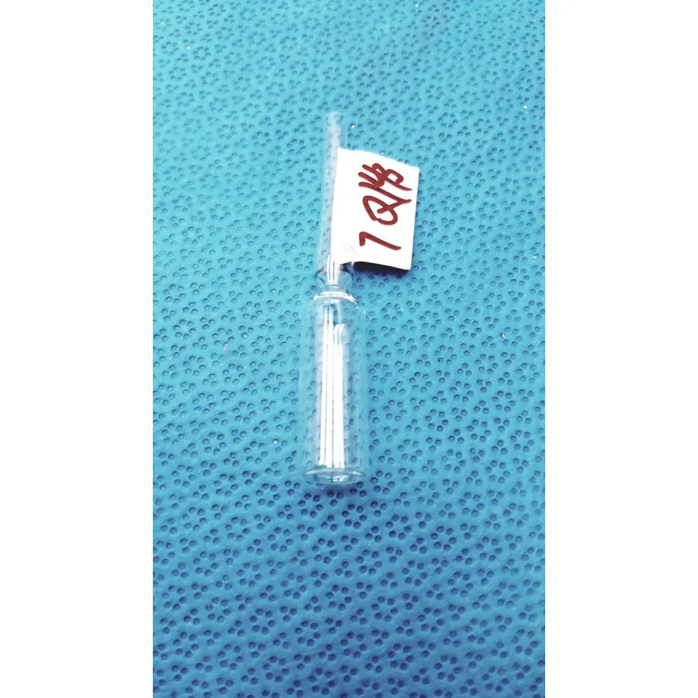1ml clear glass ampoule low borosilicate with narrow neck and white solid inside cylindrical clear glass vial