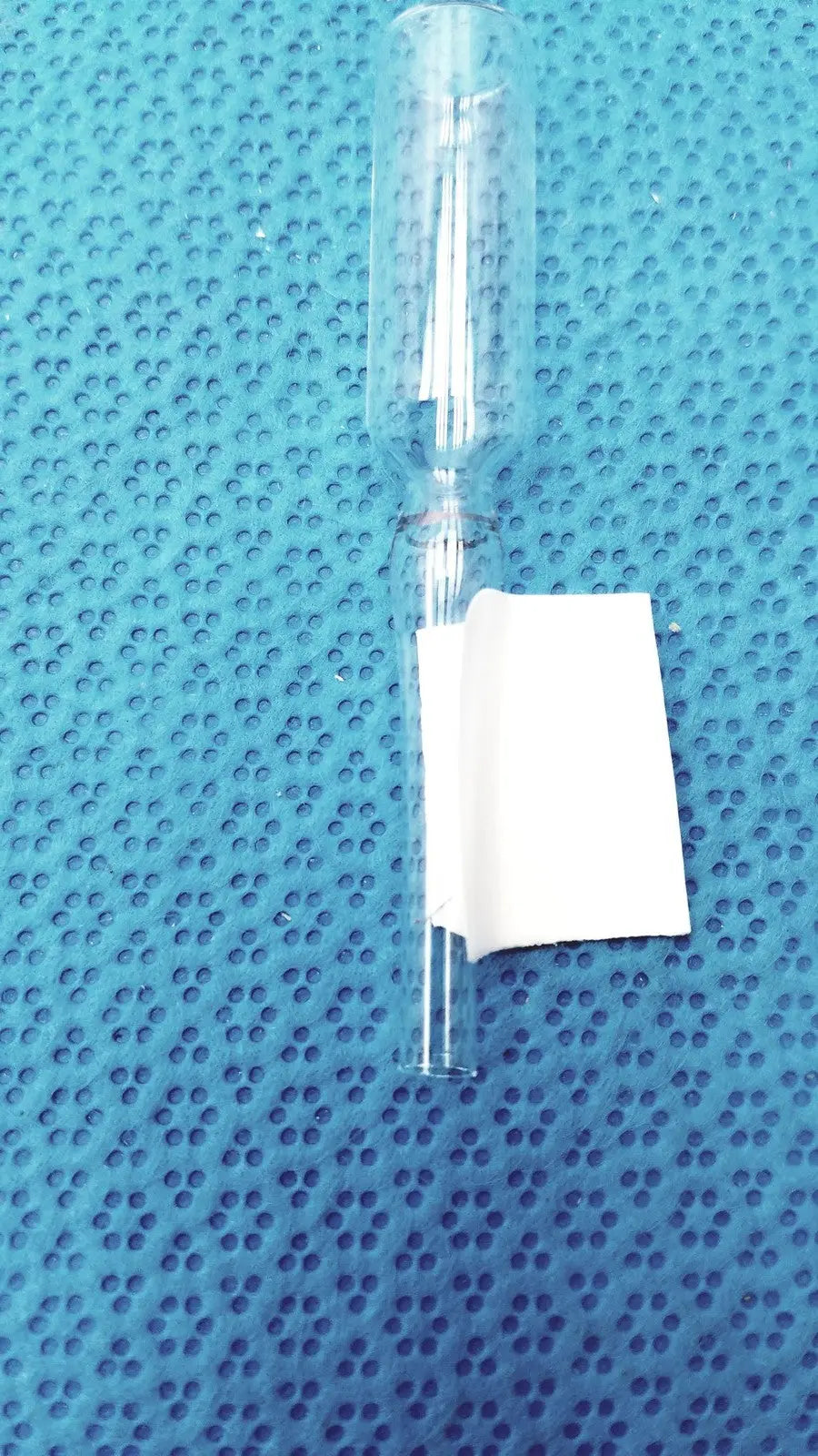 1ml clear glass ampoule low borosilicate with a white paper label wrapped around its lower section
