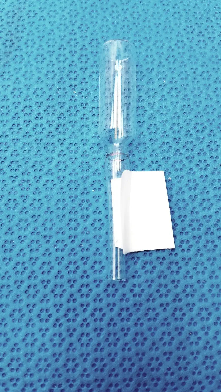 1ml clear glass ampoule low borosilicate with narrow neck and white paper label on its wider body section
