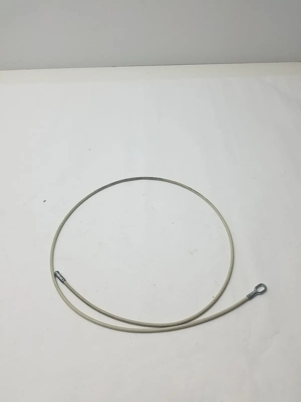 A coiled grayish metallic 2 different sided cable with two distinct end fittings for g-bbdf6-59n applications