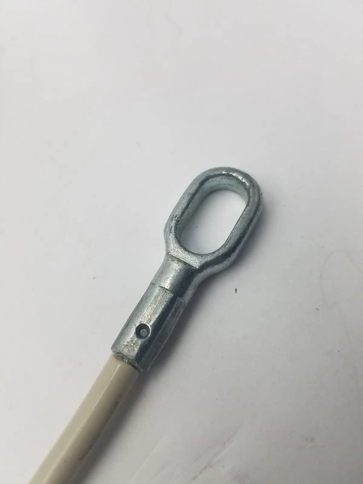 Silver metal eye bolt with cylindrical shaft and threaded hole attached to beige insulated 2 sided cable g-bbdf6-59n