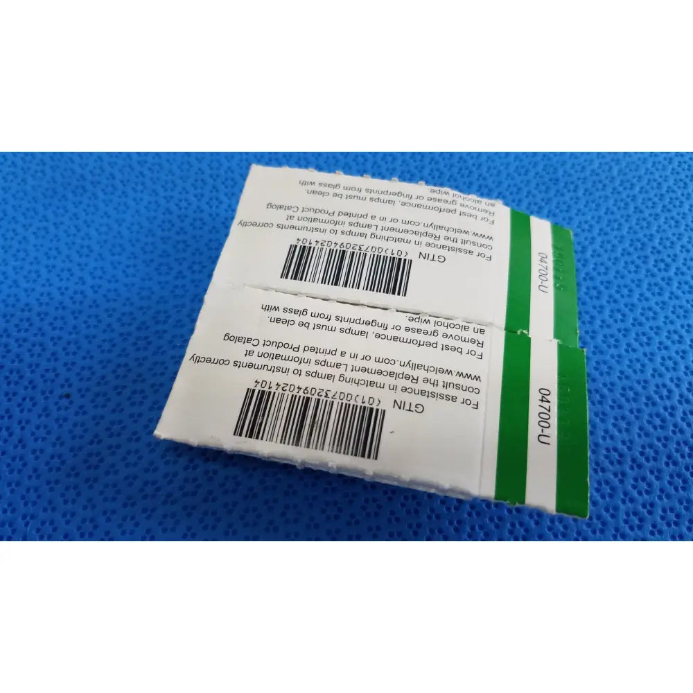 White and green rectangular packaging with barcode labels showing welch allyn allyn 04700-u replacement lamp bulb product information