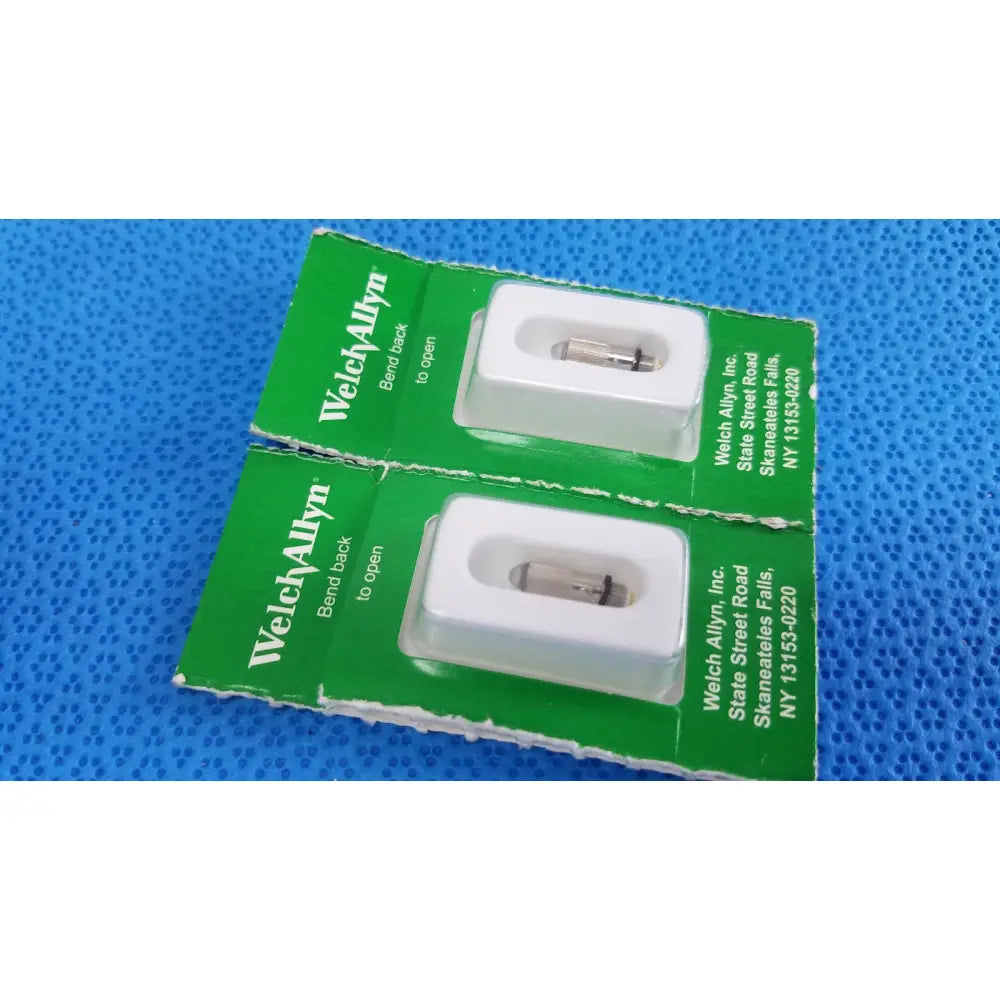 Green packaged welch allyn 04700-u replacement lamp bulbs housed in white plastic holders for medical use