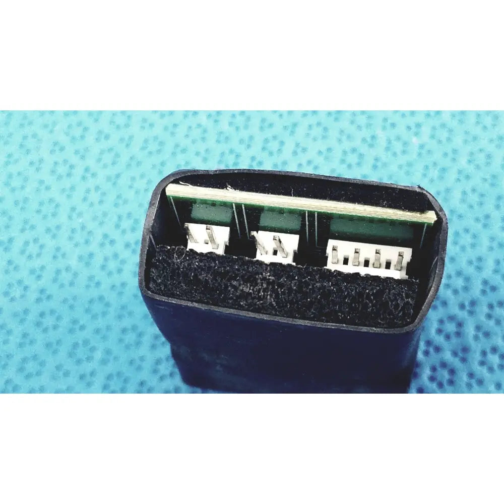 Black plastic 2-port female breakout adapter with three white pins and green circuit board for usb-a and ethernet use