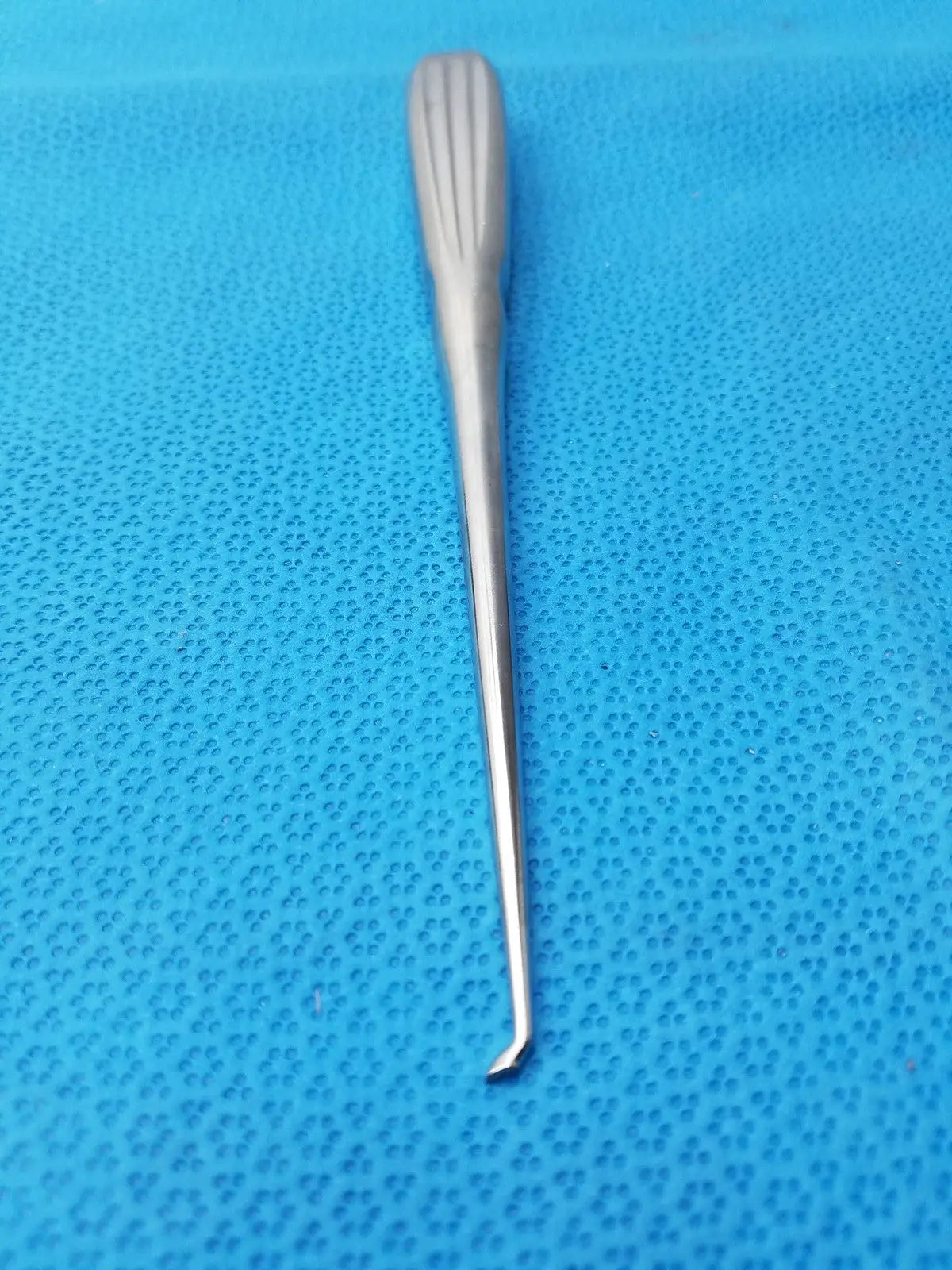 Silver spratt bone curette stainless surgical orthopedic instrument with textured ribbed handle and slender curved tip