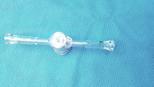 Clear plastic 24/40 borosilicate lab adapter with glass stopcock valve and central circular component for vacuum use