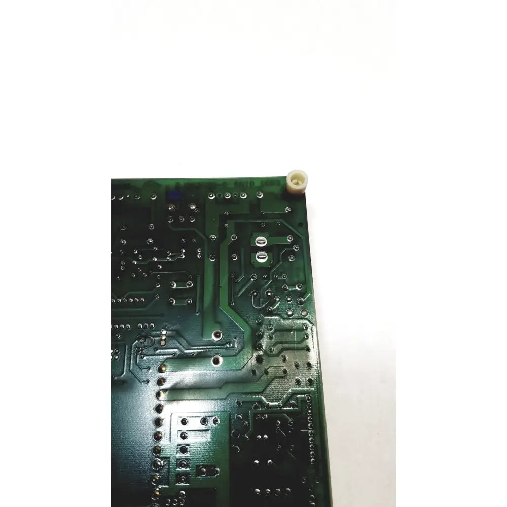 Green 2p8414t mother board with silver soldered components and a white plastic cap at the corner