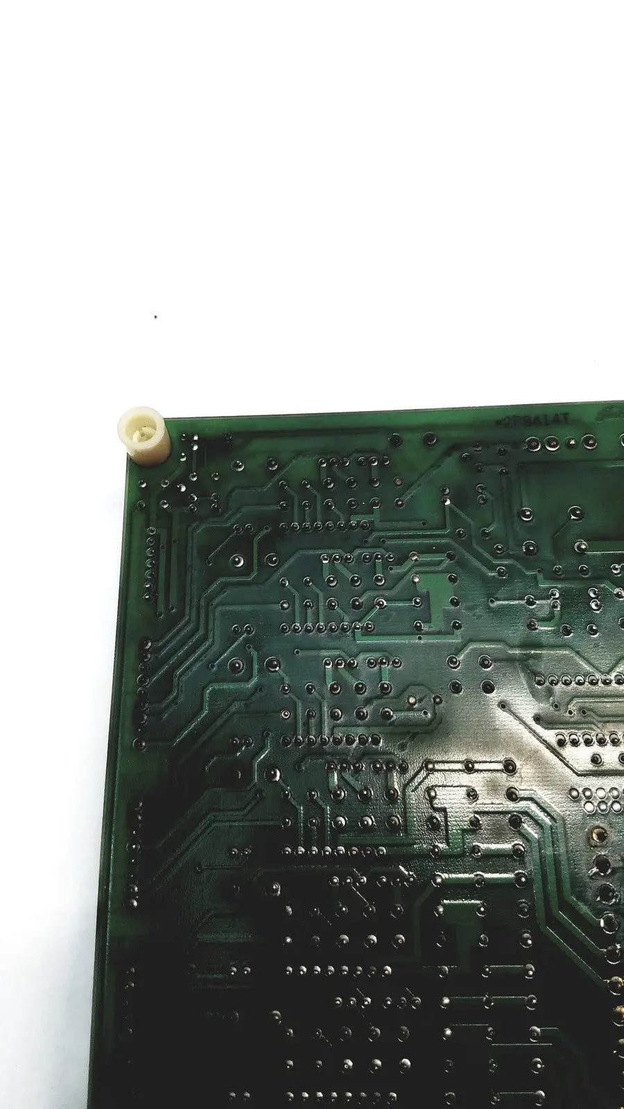 Green printed circuit board with intricate copper traces and solder pads of 2p8414t mother board model 2n3k2053-crdid-2053b