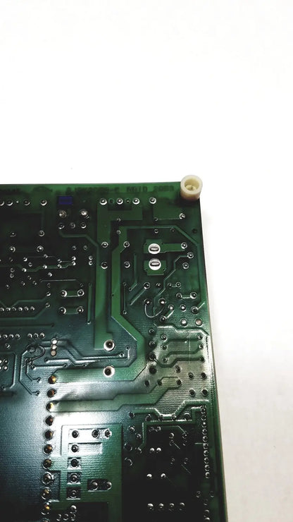 Green 2p8414t mother board with silver soldered components and a white plastic cap at the corner